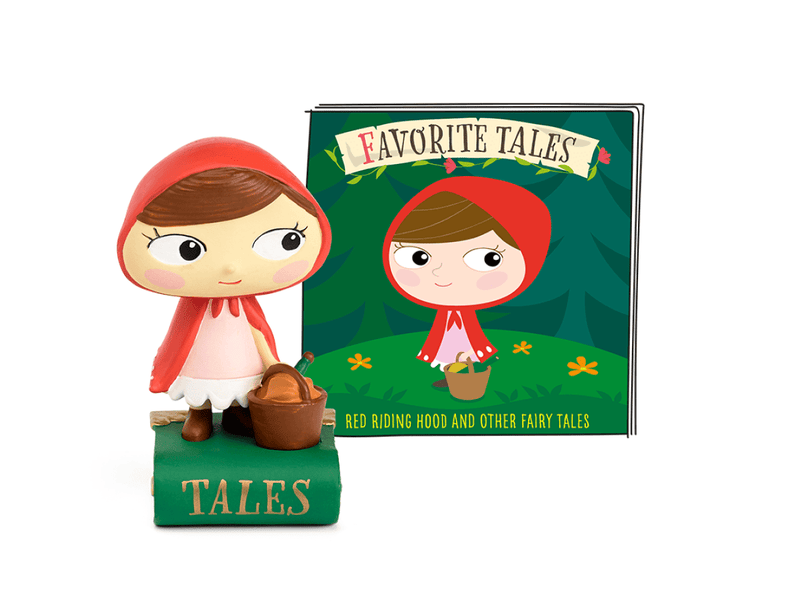 Tonie figurine of Little Red Riding Hood with basket next to green fairy tales book