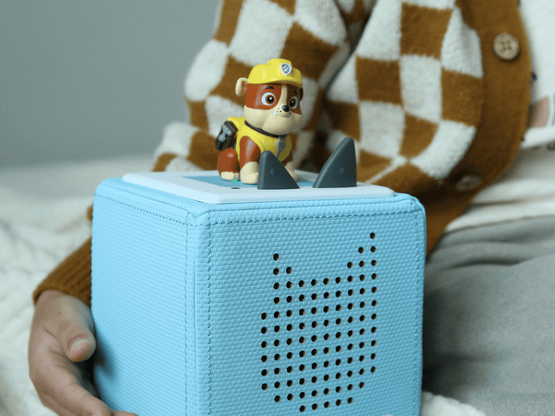 Paw Patrol Rubble Tonie figure positioned on blue Toniebox speaker in lifestyle setting