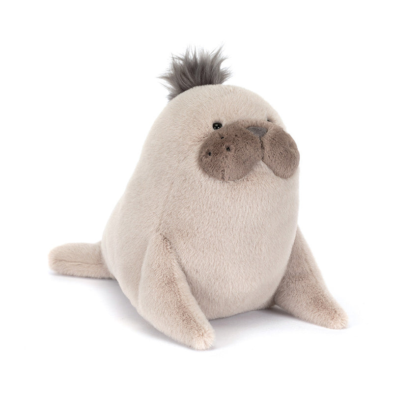 Beige plush sea lion stuffed animal with dark spiky hair tuft on head