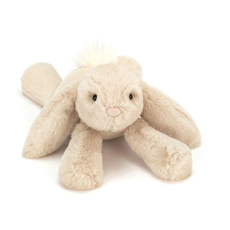 Cream colored Jellycat Smudge Rabbit stuffed animal lying flat on white background