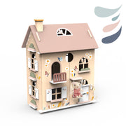 Wooden dollhouse with pink roof, floral decorations, multiple rooms, balconies, and small teddy bear figure