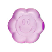 Purple translucent flower-shaped squishy toy with smiley face design on white background