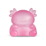 Pink translucent squishy toy with cute face and small horns on white background