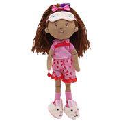 A plush doll with brown yarn hair, a white visor with a pink bow, a pink top, and pink shorts with red strawberry patterns, standing against a plain white background.