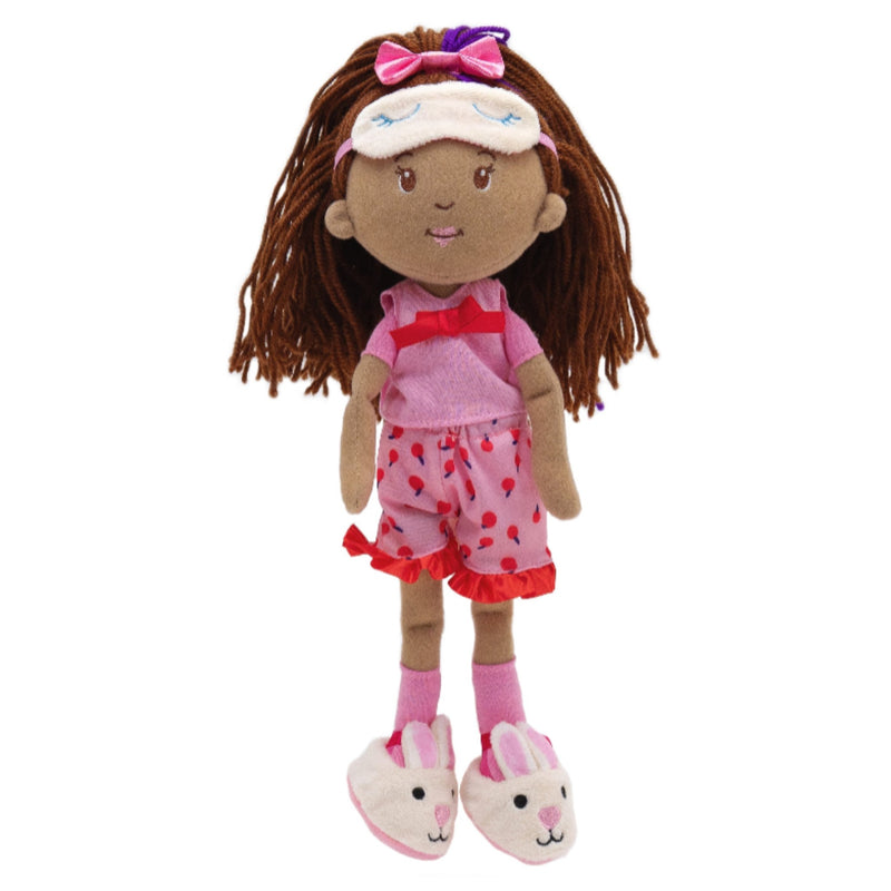 A plush doll with brown yarn hair, a white visor with a pink bow, a pink top, and pink shorts with red strawberry patterns, standing against a plain white background.