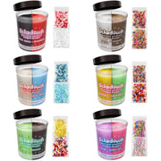Six Geladough scented candle jars arranged in a 2x3 grid on a white background, each shown with its black lid open and small packets of colorful sprinkles beside it. The candles feature split-color wax designs in red/black, silver/brown, blue/white, yellow/green, green/brown, and purple/pink, with labels naming flavors such as cherry strawberry, cinnamon roll, cotton candy, lemon watermelon, chocolate caramel, and bubble gum.