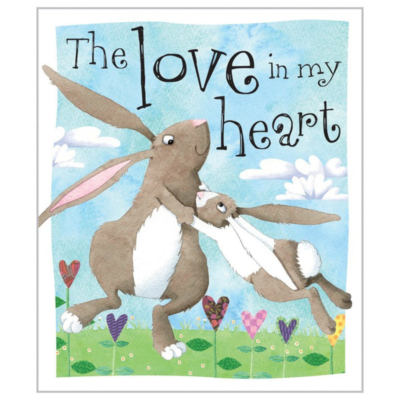 Book about two bunnies hugging with 'The Love in my Heart' text against a blue sky with clouds.