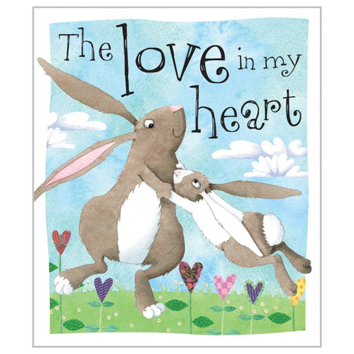 Book about two bunnies hugging with 'The Love in my Heart' text against a blue sky with clouds.