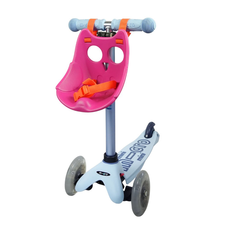 Children's scooter with a pink Scootaseatz and orange straps on a white background