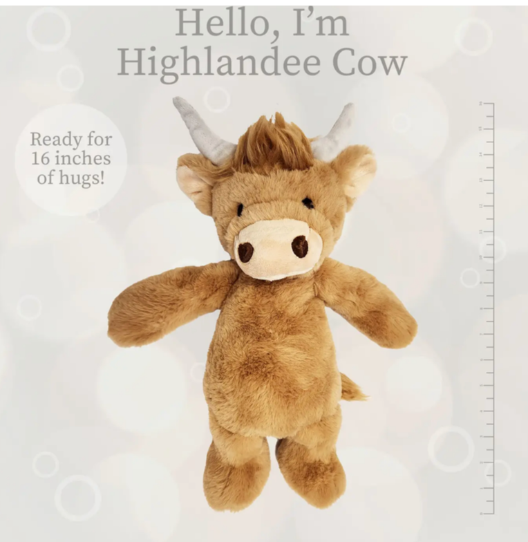 Brown Highland cow plush toy with horns and fluffy hair on white background