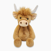 Brown Highland cow plush toy with fuzzy hair and white horns on white background