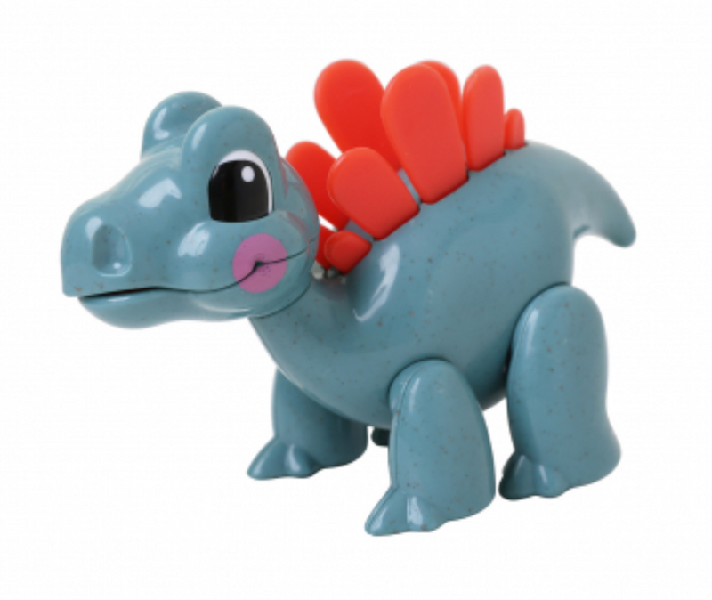 Blue plastic toy stegosaurus with red spikes on white background