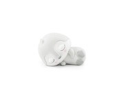 White plush penguin Tonie figure lying on its side with closed eyes and peaceful expression