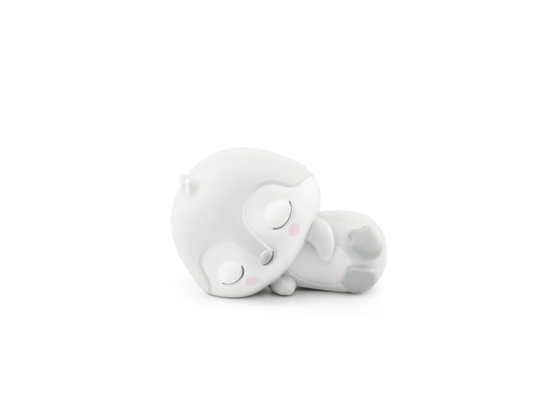 White plush penguin Tonie figure lying on its side with closed eyes and peaceful expression