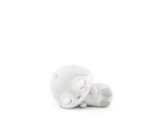 White sleeping penguin Tonie figure lying on side against green background