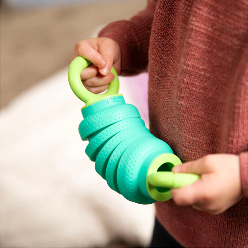 Child holding a green and teal Pully from Smart Toys. 