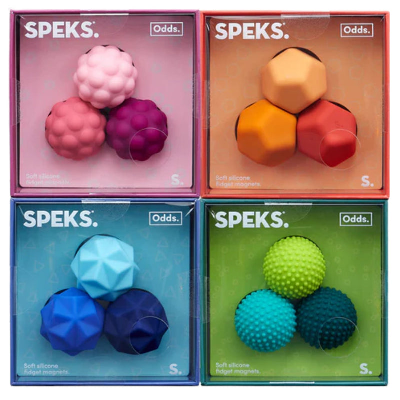 Four packaged SPEKS. soft silicone budget magnets and target magnets arranged in a 2x2 grid, each box showing three colorful spherical magnets inside a translucent colored case.
