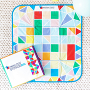 Magna-Tiles Storage Bin and Interactive Play-Mat with colorful geometric pattern and folding design