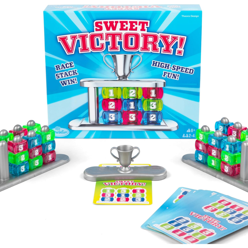 Sweet Victory board game set with colorful cubes and trophy against a white background.