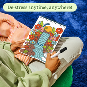 Person coloring FlowArt jungle waterfall design with flowers in relaxing setting