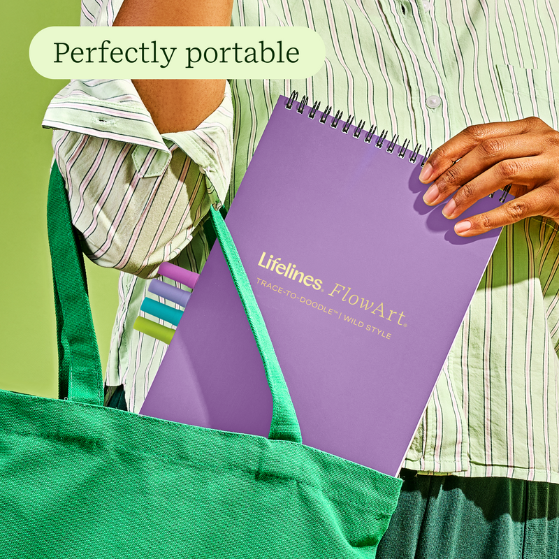 Purple Lifelines FlowArt trace-to-doodle notebook shown in green tote bag lifestyle shot
