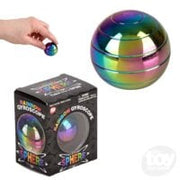 Rainbow metallic gyroscope sphere being held by hand with black packaging box