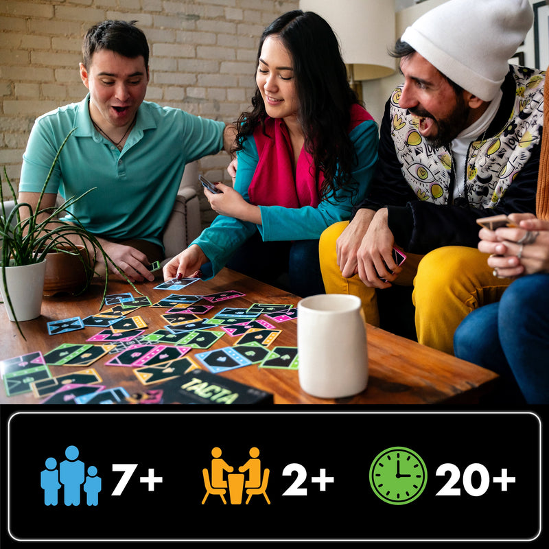 Three friends playing TACTA card game together on wooden table