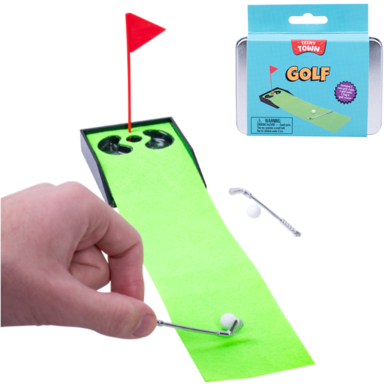 Miniature golf set with green mat, red flag, and packaging on a white background.