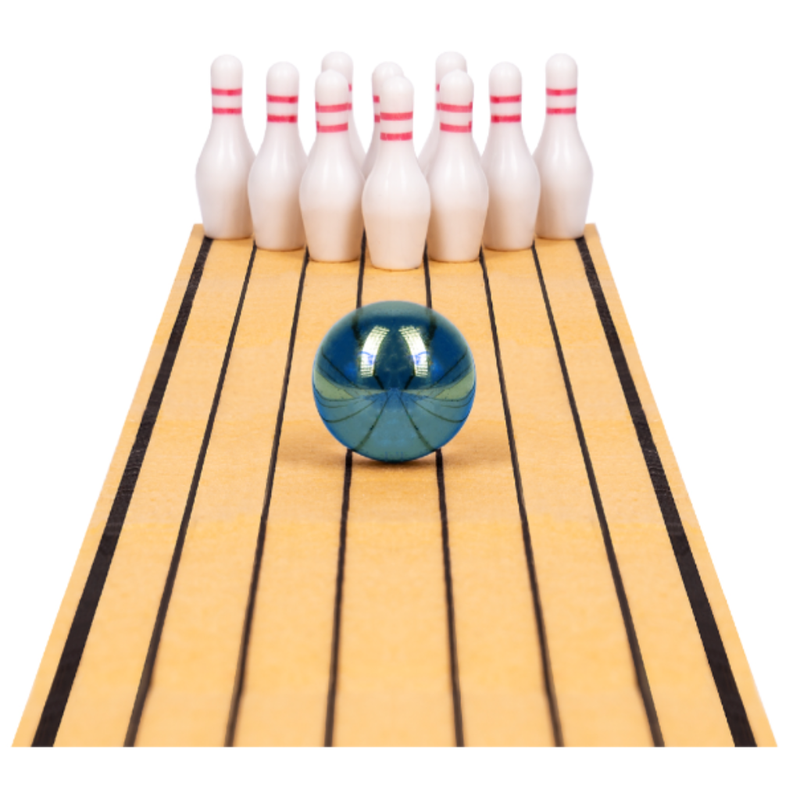 Blue bowling ball on a miniature wooden lane with white bowling pins.