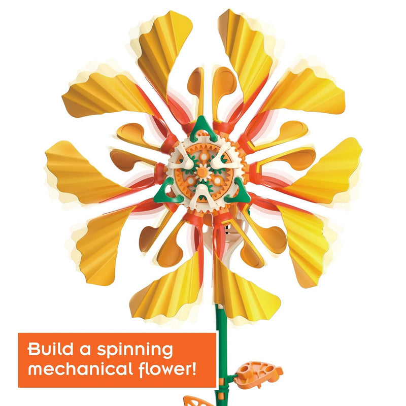 A colorful mechanical flower wind spinner with yellow petals, orange and green accents, and a central gear system, shown on a white background with an orange text banner at the bottom left that reads 'Build a spinning mechanical flower'.