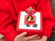 Red Tonie figurine of Mr. Incredible character on Toniebox held in hands