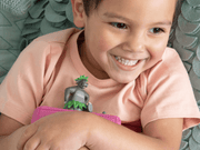 Child playing with gray Jungle Book Tonie figure featuring character with green leafy details