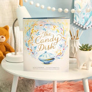 The Candy Dish book by Compendium displayed on white table in styled nursery setting