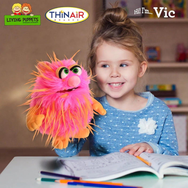 Child holding a colorful puppet named Vic from Living Puppets and ThinAir Puppetry logos.