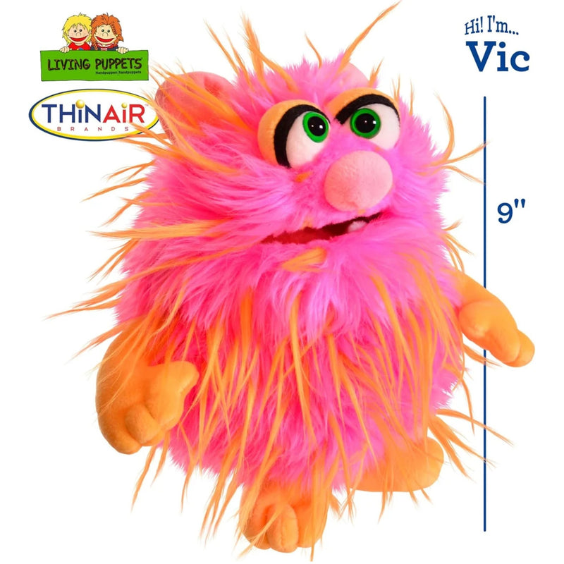 A pink and orange furry monster puppet by ThinAir Living Puppets toy labeled Vic.