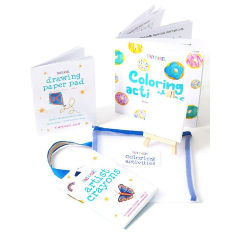 Artistic supplies including a coloring book, paper pad, and crayons on a white background