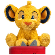A plush lion cub toy with golden yellow fur, dark blue inner ears, and a red nose, sitting on a red base against a plain white background.