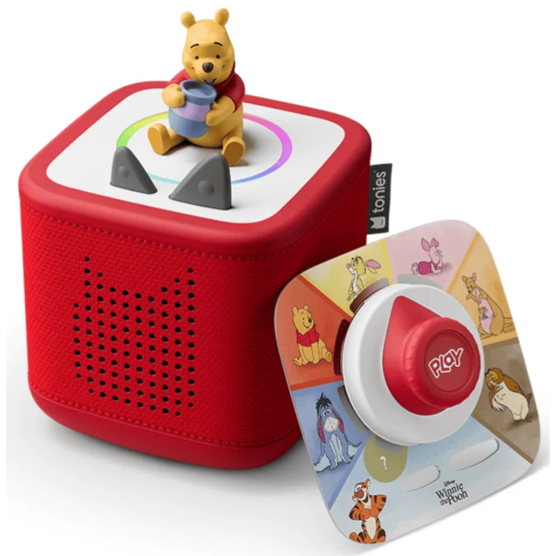 A red Tonles baby sound box with a Winnie the Pooh figurine on top, shown next to its colorful printed dial cover featuring characters like Winnie the Pooh, Tigger, and Piglet.