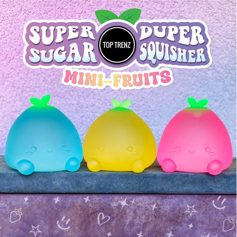 Three mini-fruit-shaped squishy toys in blue, yellow, and pink, displayed on a shelf under a purple 'Super Super Squisher Mini-Fruits' logo by Top Trenz.