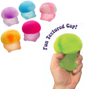 A hand holds a small mushroom-shaped silicone cleansing brush with a bright green textured cap and pale green base. Five additional color variants are shown floating on the left, and purple text reads 'Fun Textured Cap!' on a white background.