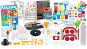 A Kidz Labs science kit laid out on a white background, containing various colorful components such as bottles, test tubes, plastic dishes, a black cone, orange geometric frames, and printed instruction sheets.