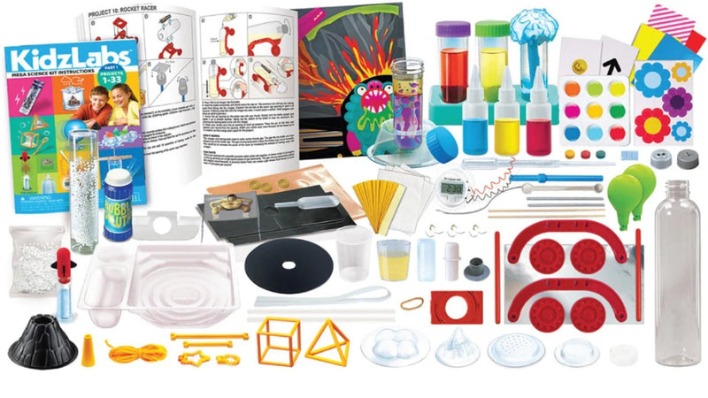 A Kidz Labs science kit laid out on a white background, containing various colorful components such as bottles, test tubes, plastic dishes, a black cone, orange geometric frames, and printed instruction sheets.