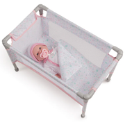Baby doll in a portable crib with pink and white design on a white background.