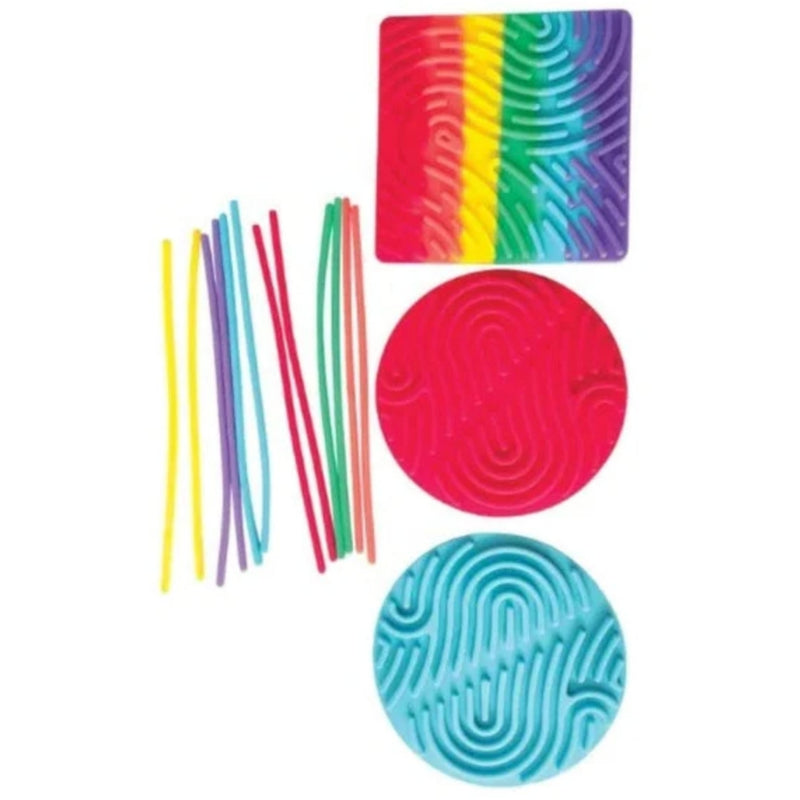 A colorful sensory toy set on a white background, featuring a square rainbow-patterned board, two textured circular mats in pink and blue, and several thin rainbow-colored sticks.