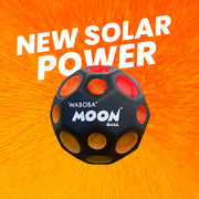 Waboba Moon Ball with crater-like holes on orange sunburst background