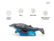 Tonies whale figurine on blue wave base with National Geographic Kids branding