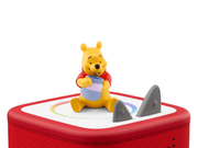 Winnie the Pooh Tonie figure sitting on red Toniebox speaker with honey pot
