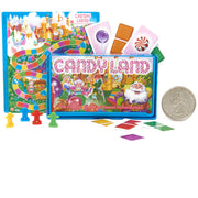 Candy Land board game set with a colorful game board, blue playmat, illustrated cards, game pieces, and a quarter coin on a white background.
