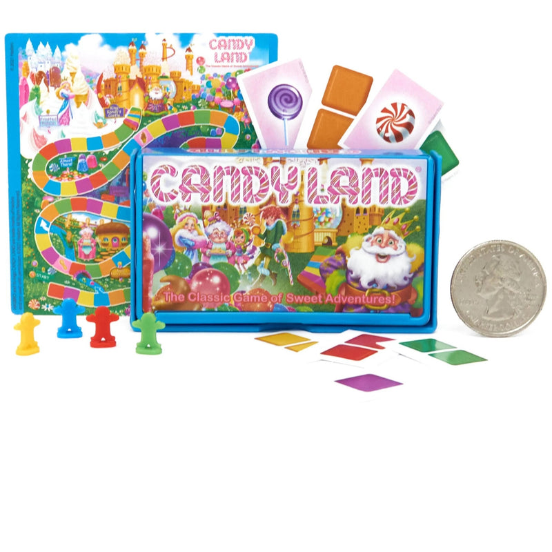 Candy Land board game set with a colorful game board, blue playmat, illustrated cards, game pieces, and a quarter coin on a white background.