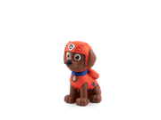 Tonie figurine of Zuma from Paw Patrol in red rescue uniform on plain background